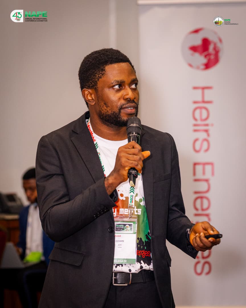 Young professionals in the audience applauding a pitch